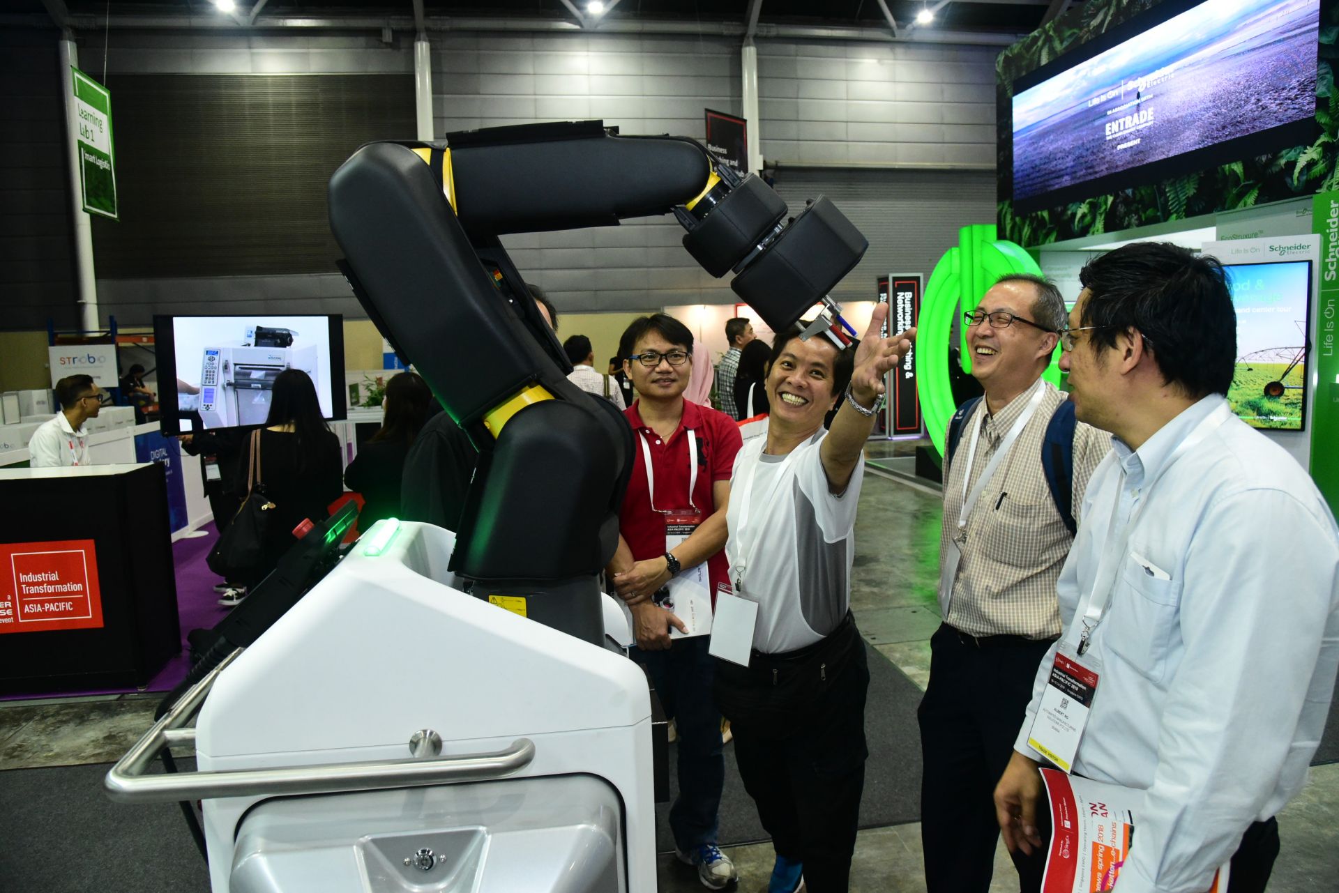 Exhibitors demonstrating their robotics solutions to visitors