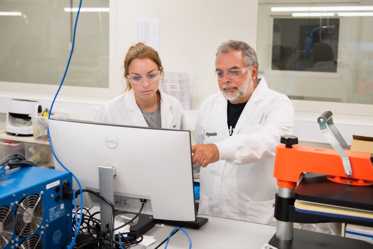 CTO Professor Gerry Swiegers (right) discussing test results in Hysata reliability laboratory