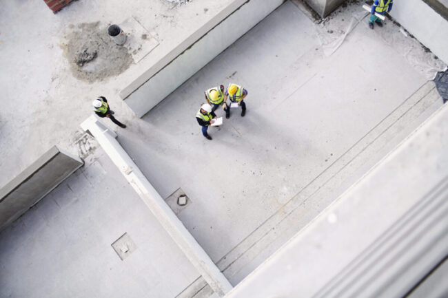 Overhead view of construction workers and engineers at construction site