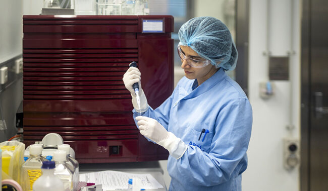 team member pipetting small